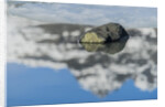 Rock with sky reflected in water. by Anonymous