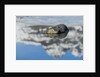 Rock with sky reflected in water. by Anonymous