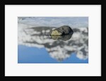 Rock with sky reflected in water. by Anonymous