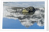 Rock with sky reflected in water. by Anonymous