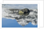 Rock with sky reflected in water. by Anonymous
