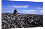 Stacked rock sculpture among rocky coastline. by Anonymous