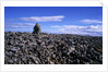 Stacked rock sculpture among rocky coastline. by Anonymous