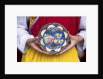 Woman holding wooden plate, China by Anonymous