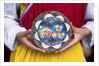 Woman holding wooden plate, China by Anonymous
