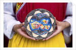 Woman holding wooden plate, China by Anonymous