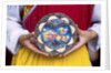 Woman holding wooden plate, China by Anonymous