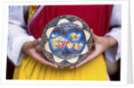Woman holding wooden plate, China by Anonymous