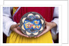 Woman holding wooden plate, China by Anonymous