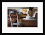 Woman watching TV with crutches by Anonymous