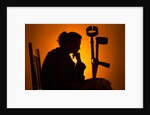 Woman seated with crutches by Anonymous