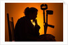 Woman seated with crutches by Anonymous