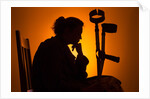 Woman seated with crutches by Anonymous