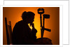 Woman seated with crutches by Anonymous