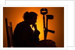 Woman seated with crutches by Anonymous