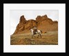 Cowgirl at Full Gallop with red rock hills by Corbis