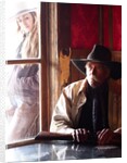 Cowboy with rifle and Cowgirl looking over his shoulder by Anonymous