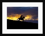 Cowboy in silhouette with sunset by Anonymous