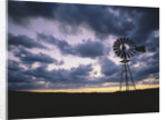 Windmill Silhouette Under Broken Clouds by Anonymous