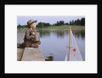 Boy Sitting by Lake in Cowboy Hat by Anonymous