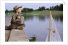 Boy Sitting by Lake in Cowboy Hat by Anonymous