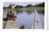 Boy Sitting by Lake in Cowboy Hat by Anonymous
