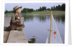 Boy Sitting by Lake in Cowboy Hat by Anonymous