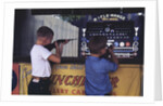 Children Firing Air Rifles at Fair Booth by Anonymous