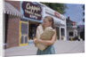 Girl Carrying Paper Shopping Bags by Anonymous