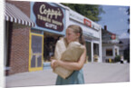 Girl Carrying Paper Shopping Bags by Anonymous