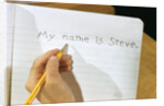 Schoolboy Writing Name in Notebook by Anonymous