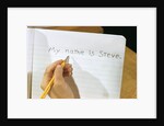 Schoolboy Writing Name in Notebook by Anonymous