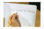 Schoolboy Writing Name in Notebook by Anonymous