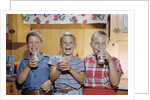 Happy Children Enjoying Glass of Cold Milk by Anonymous