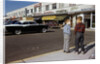 Boys Standing Alongside Strip Mall Parking Lot by Anonymous