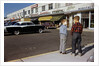 Boys Standing Alongside Strip Mall Parking Lot by Anonymous
