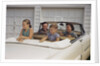 Family Sitting in Car Outside Garage by Anonymous