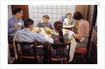 Family Eating Together at Dinner Table by Anonymous