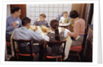 Family Eating Together at Dinner Table by Anonymous