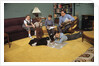 Family Sitting Around Living Room by Anonymous