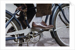 Man Riding Bicycle in Dress Shoes by Anonymous