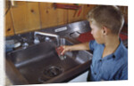 Boy Getting Glass of Tap Water by Anonymous