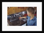 Boy Getting Glass of Tap Water by Anonymous