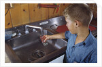 Boy Getting Glass of Tap Water by Anonymous