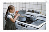 Girl Stirring Soup in Kitchen by Anonymous