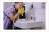 Girl Washing Her Face at Sink by Anonymous