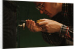Man Fixing Knob on Screen Door by Anonymous