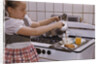 Girl Preparing Breakfast in Kitchen by Anonymous