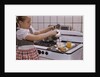 Girl Preparing Breakfast in Kitchen by Anonymous