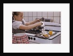 Girl Preparing Breakfast in Kitchen by Anonymous
